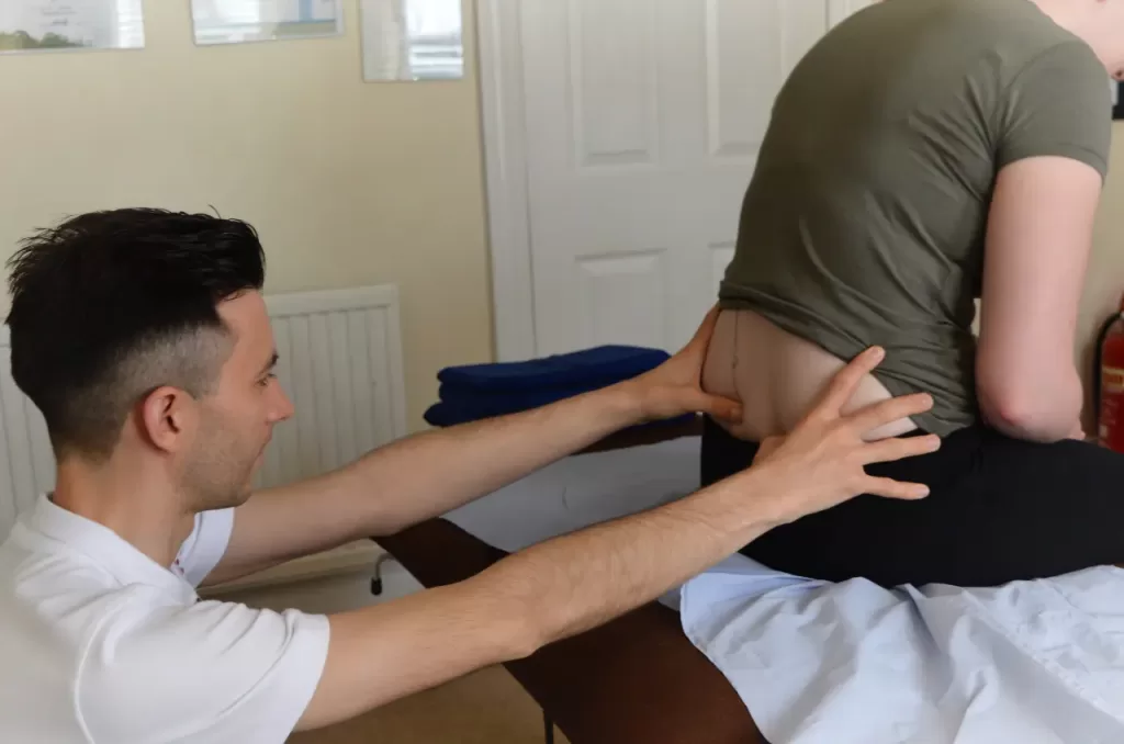 Alex Moore, founder of Thrive Studio, providing sports therapy treatment to a dancer for pain relief and improved performance