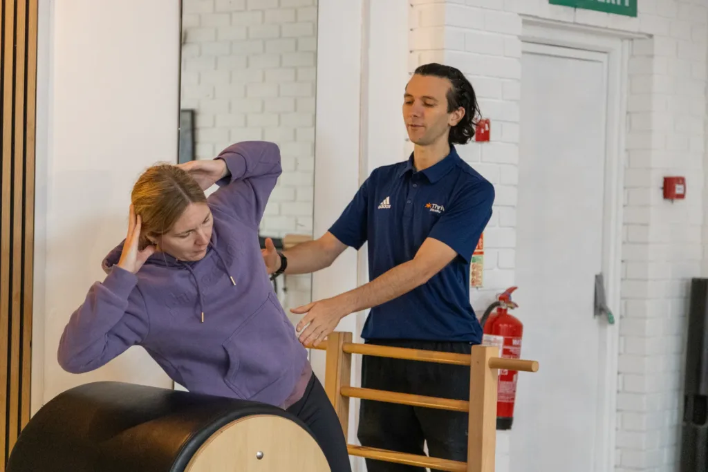 Hands-on correction on the Ladder Barrel at THRIVE Studio, Broadstone